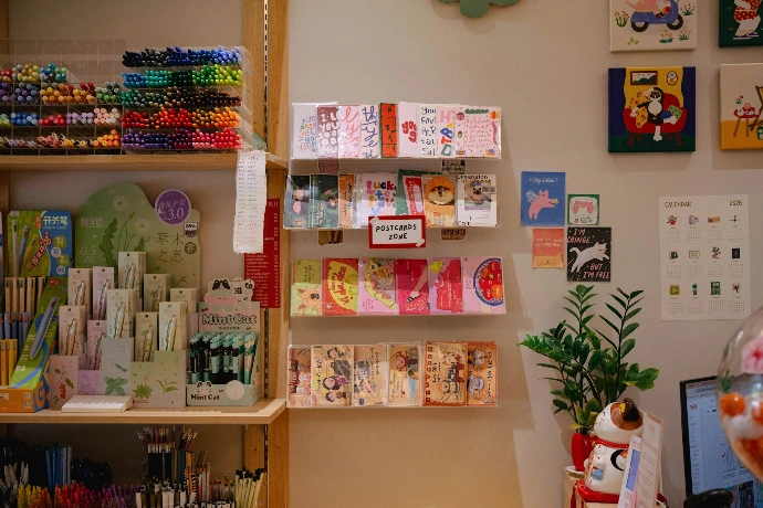 A stationery store with colorful pens and cards on display.